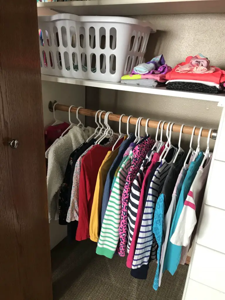 kids clothes organized in closet