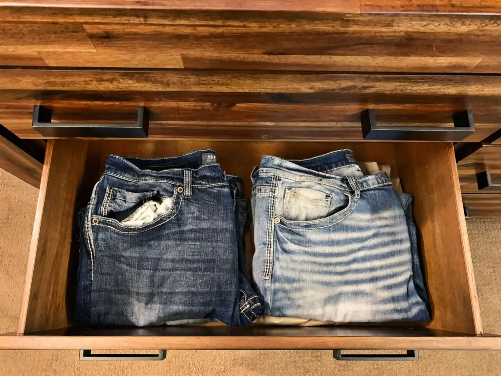 Folded pants in a drawer organized