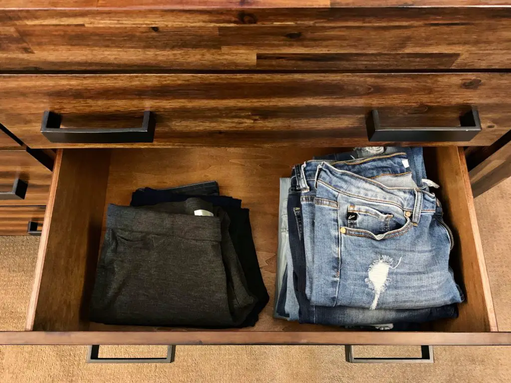 Folded pants in a drawer organized